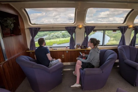 a group of people sitting in chairs in front of a window