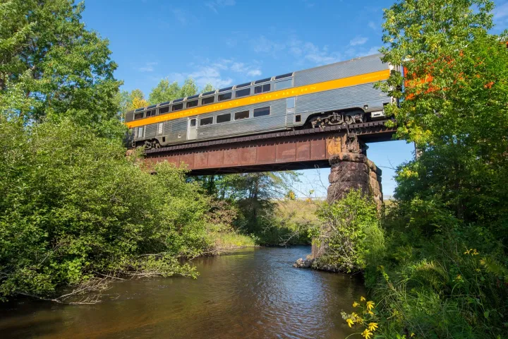a train crossing a bridge over a body of water