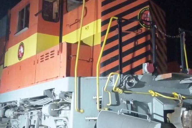 Orange and black train engine with number 1386 at night.