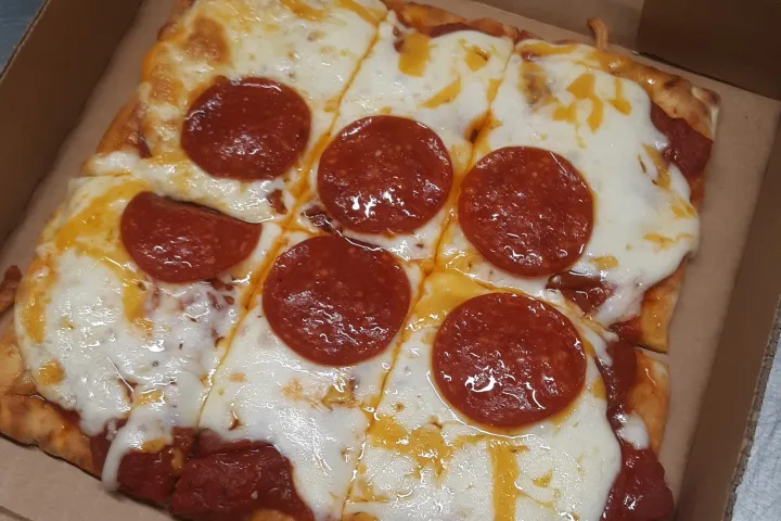 a close up of a slice of pepperoni pizza