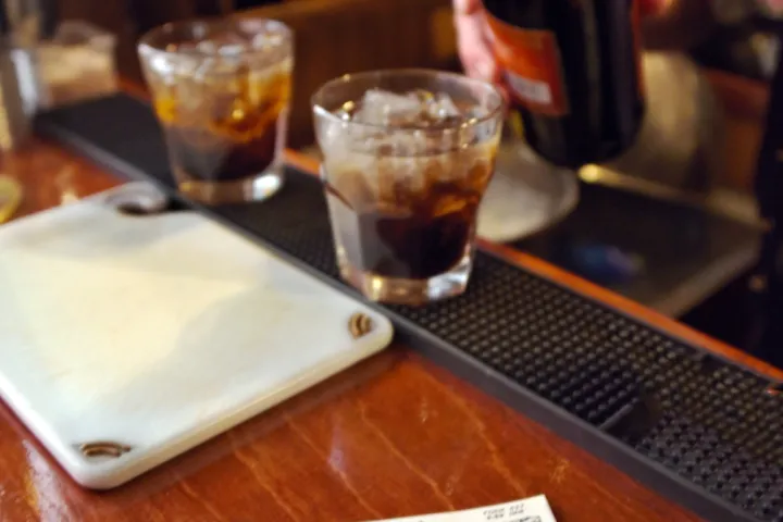 a cup of coffee sitting on top of a wooden table