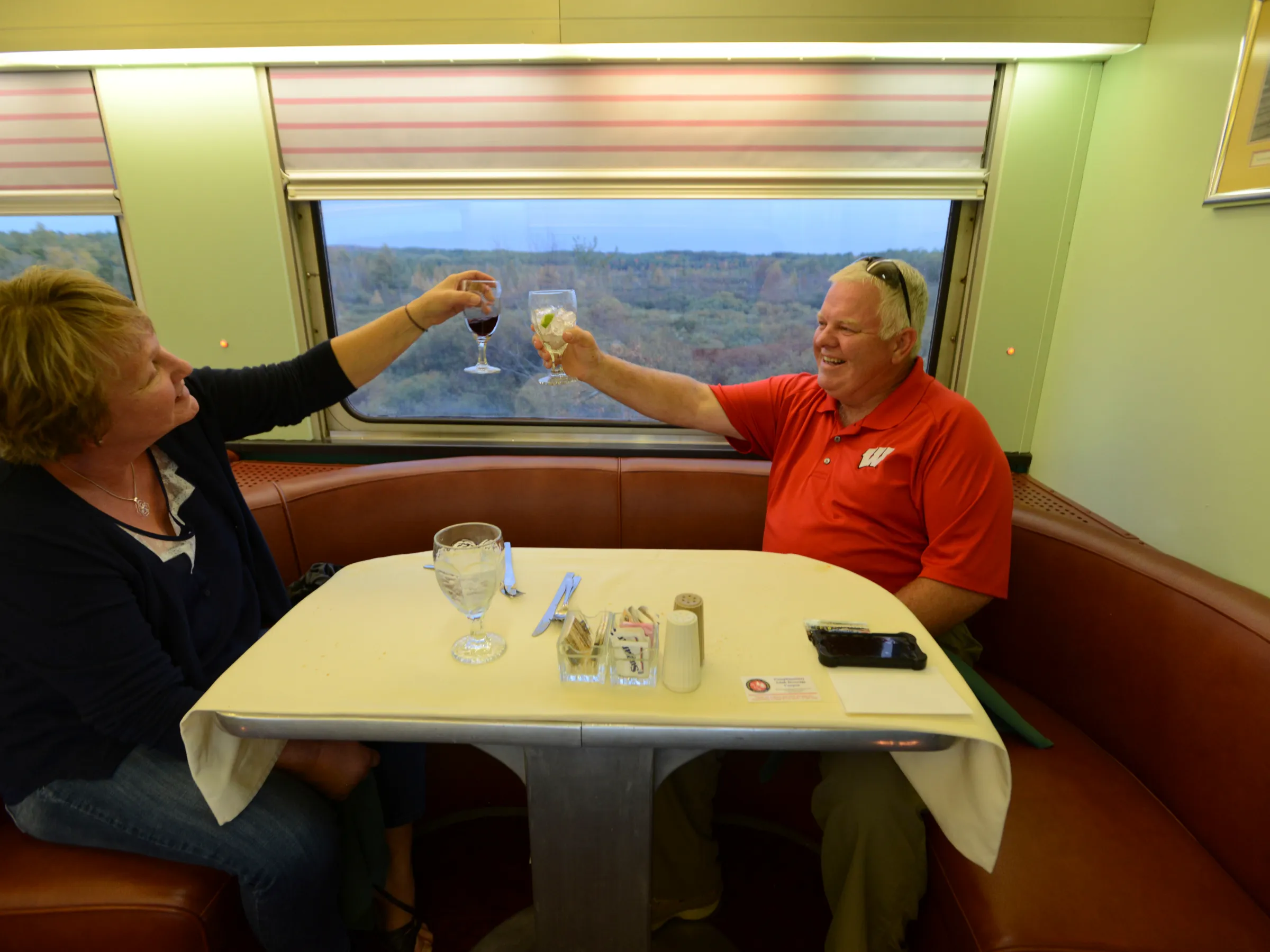 a group of people sitting at a table in front of a window