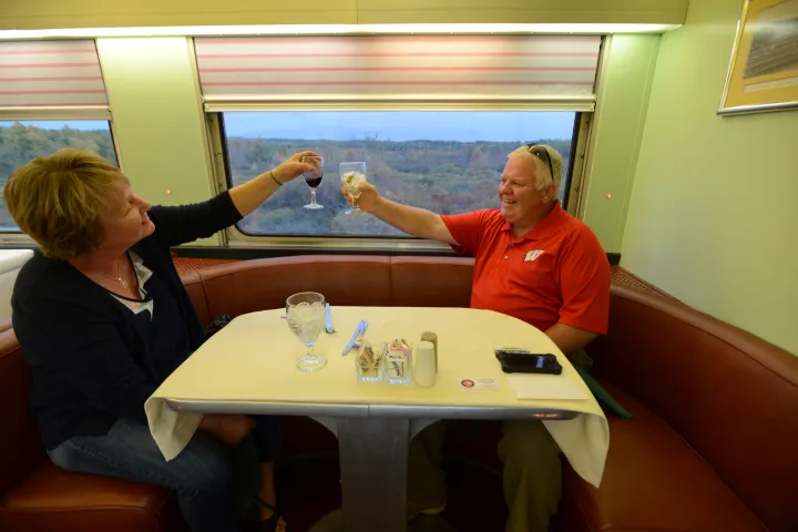 a group of people sitting at a table in front of a window